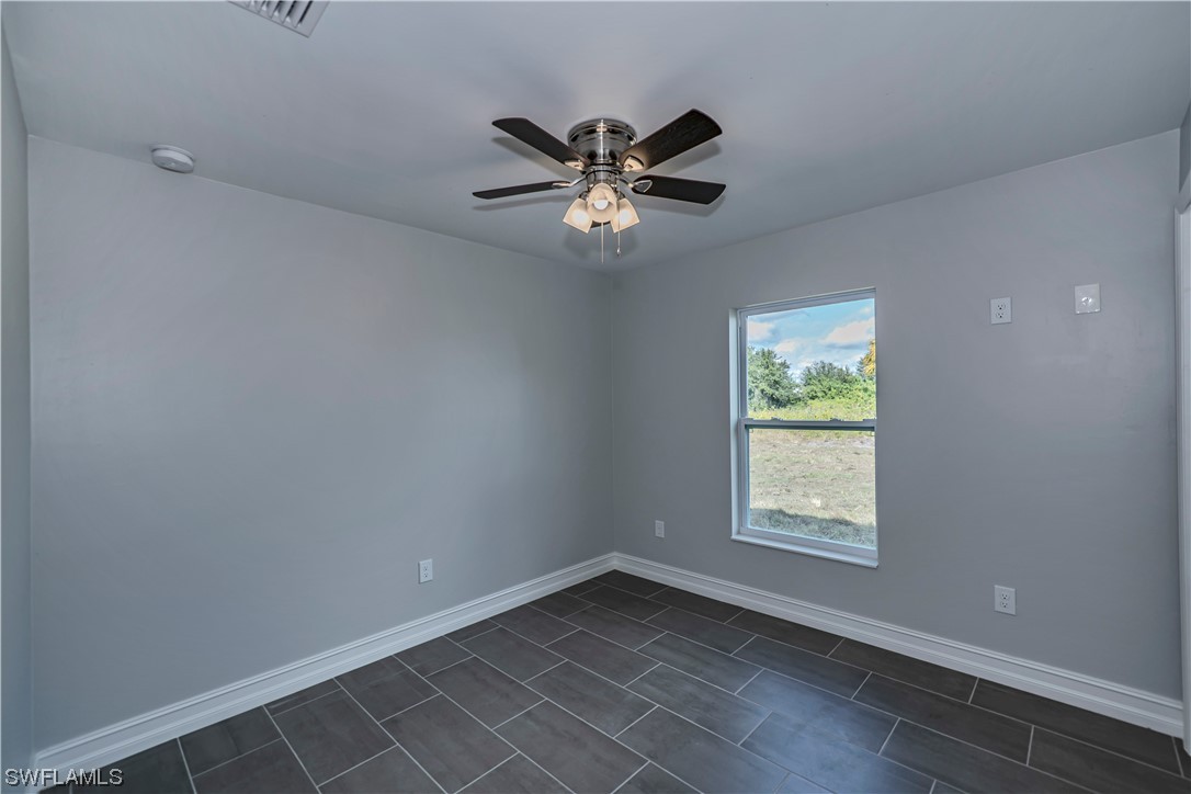 9024 Largo Circle LaBelle, FL 33935 - Photo 21 of 27 an empty room with window and ceiling fan