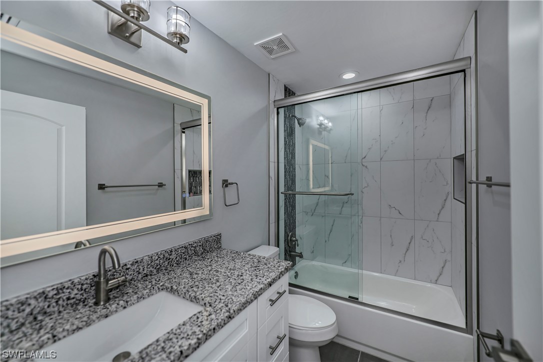 9024 Largo Circle LaBelle, FL 33935 - Photo 24 of 27 a bathroom with a granite countertop sink toilet and shower