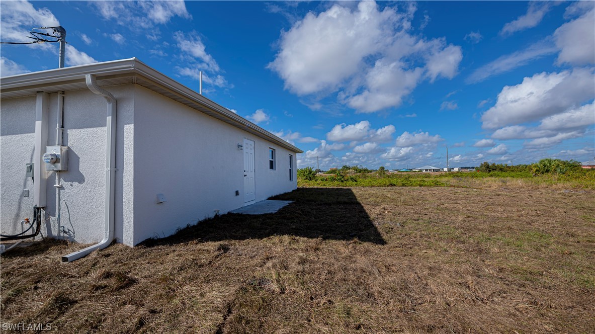9024 Largo Circle LaBelle, FL 33935 - Photo 25 of 27 a backyard of a house with lots of green space