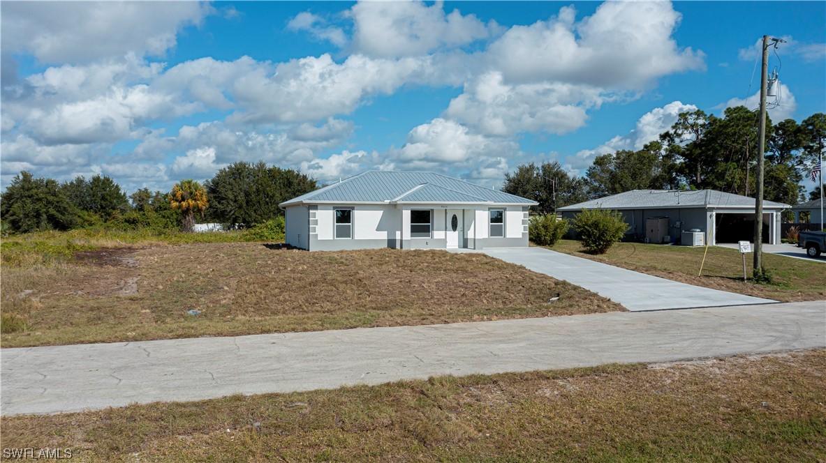 9024 Largo Circle LaBelle, FL 33935 - Photo 6 of 27 front view of house with a yard