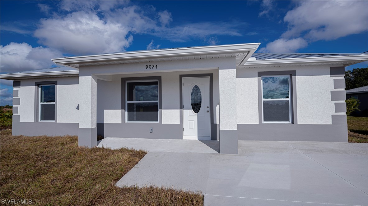 9024 Largo Circle LaBelle, FL 33935 - Photo 7 of 27 front view of a house with a yard