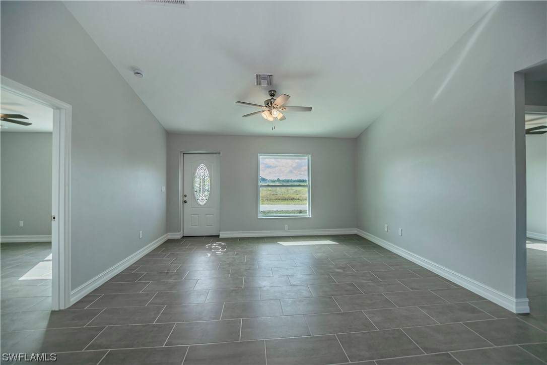 9024 Largo Circle LaBelle, FL 33935 - Photo 10 of 27 en empty room with windows and a ceiling fan