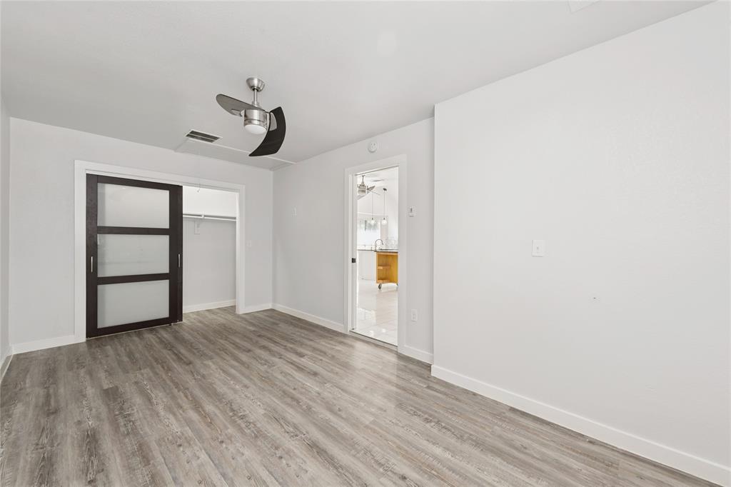 3721 Smartt Street Rowlett, TX 75088 - Photo 12 of 25 Unfurnished bedroom with light wood-style flooring, a closet, and ceiling fan
