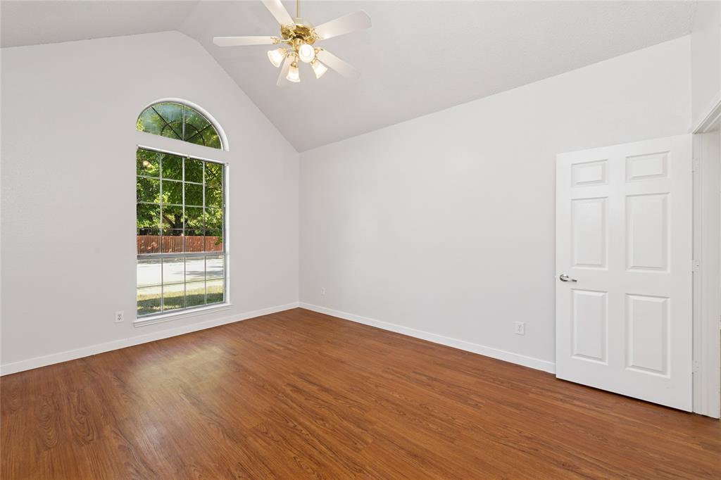 3721 Smartt Street Rowlett, TX 75088 - Photo 14 of 25 Unfurnished room featuring vaulted ceiling, dark wood-style floors, and a ceiling fan