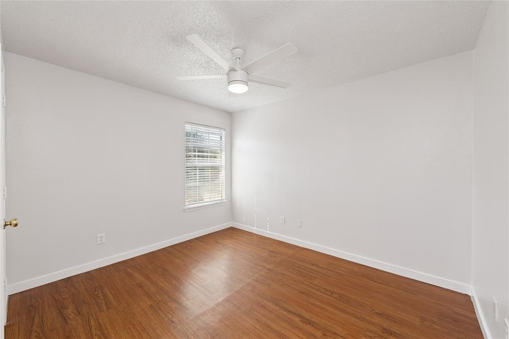 3721 Smartt Street Rowlett, TX 75088 - Photo 15 of 25 Spare room with a textured ceiling, wood finished floors, and ceiling fan
