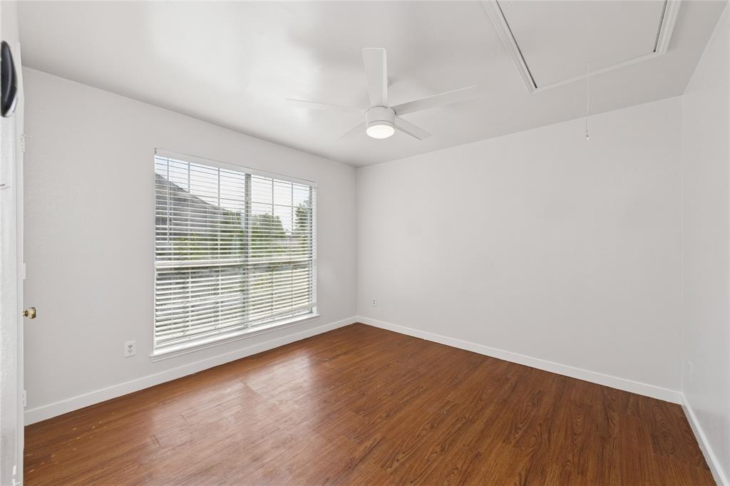 3721 Smartt Street Rowlett, TX 75088 - Photo 17 of 25 Empty room featuring attic access, dark wood finished floors, and a ceiling fan