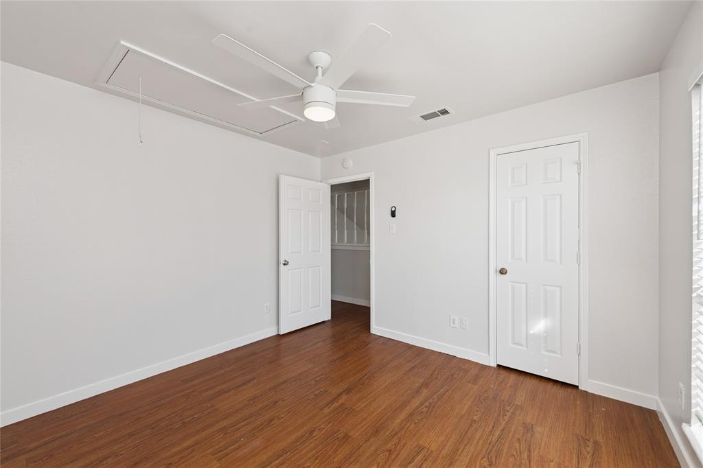 3721 Smartt Street Rowlett, TX 75088 - Photo 18 of 25 Unfurnished bedroom with attic access, dark wood-type flooring, and a ceiling fan
