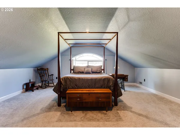 a bedroom with a bed and a television