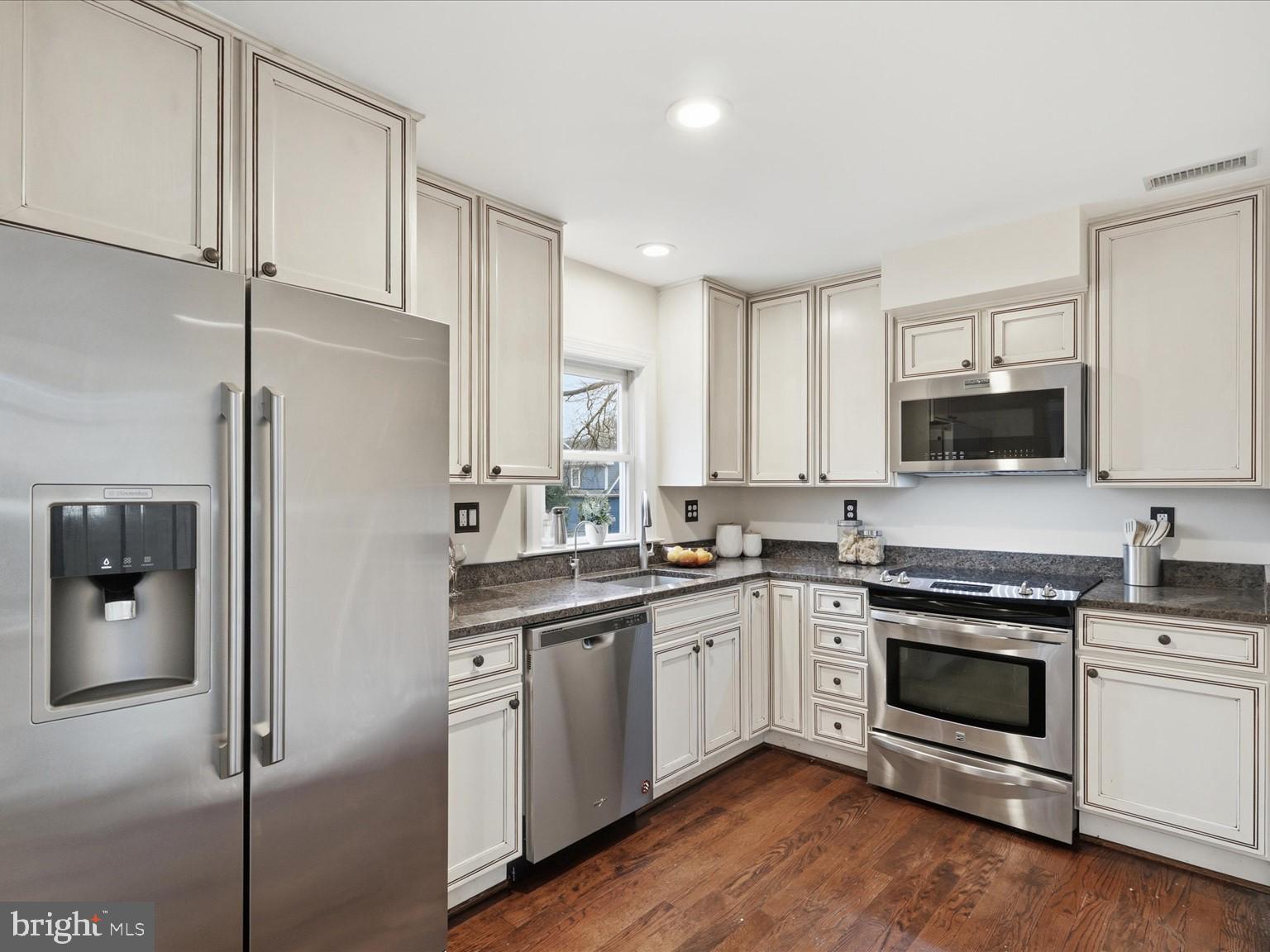 6437 Spring Terrace Falls Church, VA 22042 - Photo 13 of 42 a kitchen with a sink stainless steel appliances and white cabinets