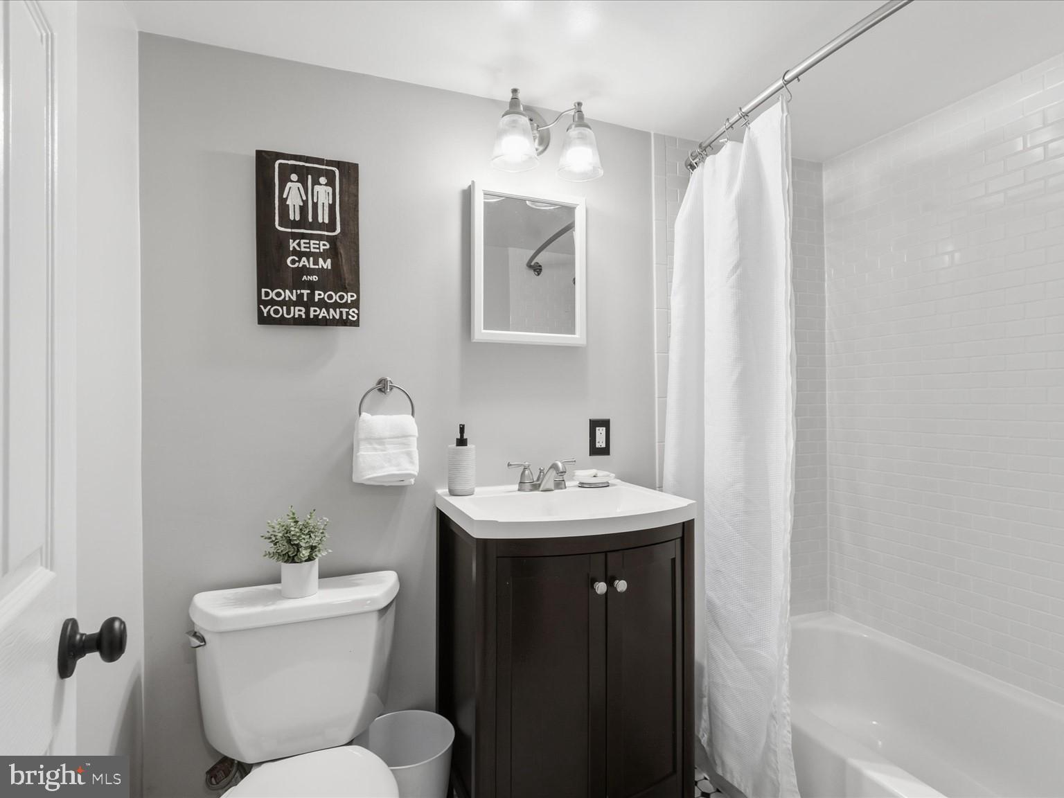 6437 Spring Terrace Falls Church, VA 22042 - Photo 28 of 42 a bathroom with a toilet sink and mirror