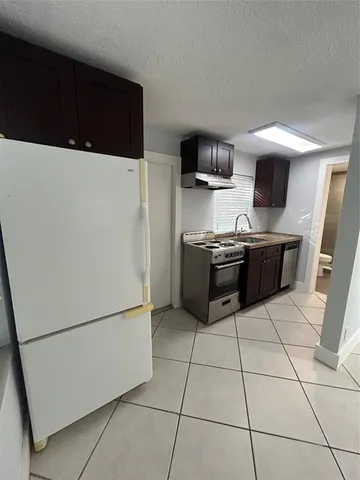 a kitchen with stainless steel appliances a refrigerator sink and microwave