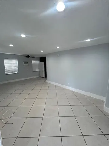 an empty room with white walls and tiles