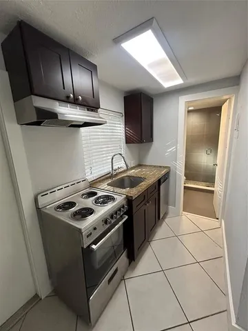 a stove top oven sitting inside of a kitchen
