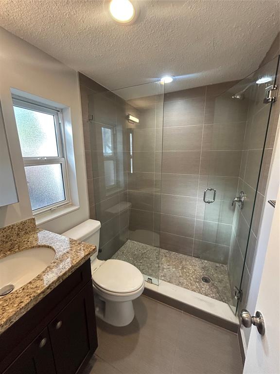 408 Northeast 7th Avenue, Unit 14 Fort Lauderdale, FL 33301 - Photo 6 of 8 a bathroom with a granite countertop sink toilet and shower