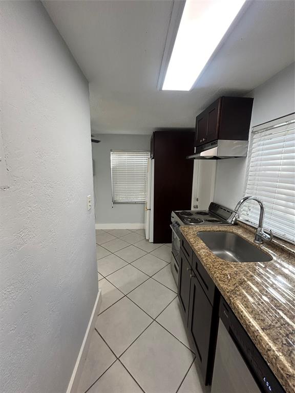 408 Northeast 7th Avenue, Unit 14 Fort Lauderdale, FL 33301 - Photo 7 of 8 a kitchen with granite countertop a sink and a stove