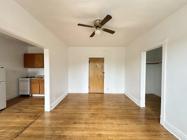 a view of a livingroom with a ceiling fan and wooden floor