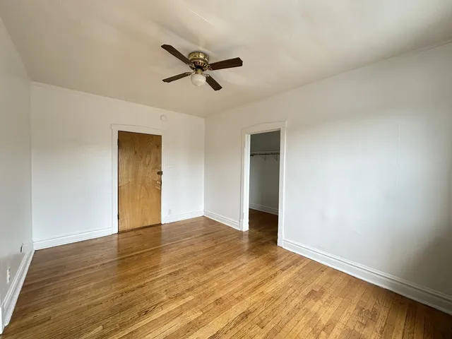 a view of an empty room and wooden floor