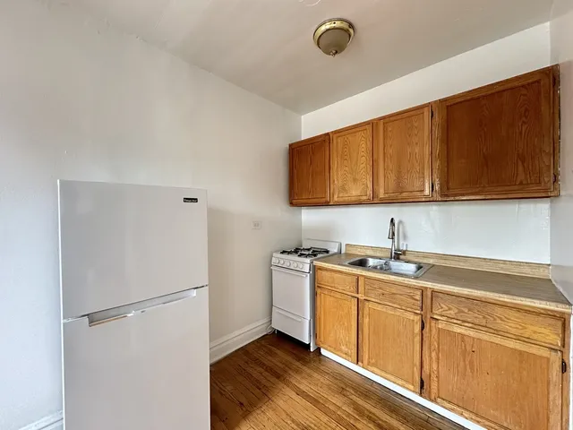 a kitchen with a sink a stove and refrigerator