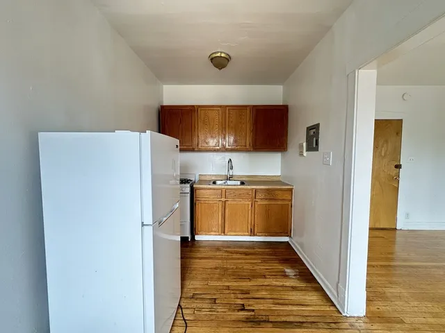 a kitchen with a refrigerator and a stove