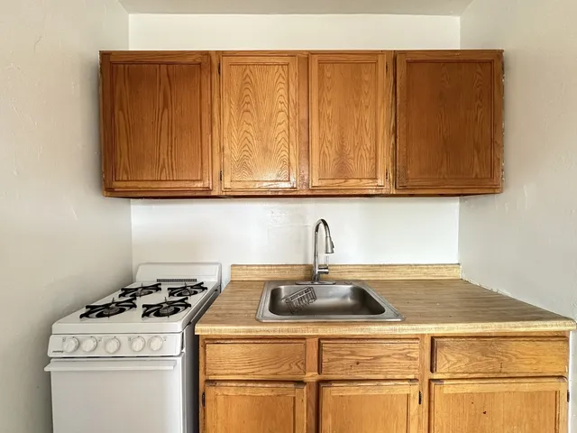 a kitchen with a stove and a sink