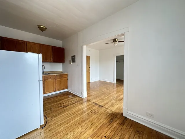 a view of a kitchen with wooden floor and a sink