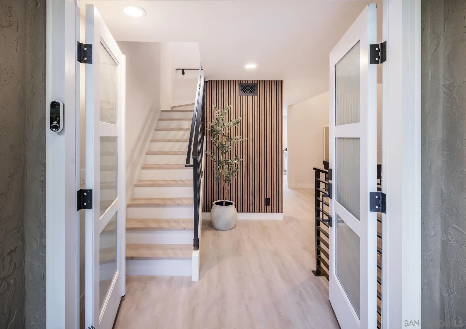 a view of a hallway with wooden floor and entryway