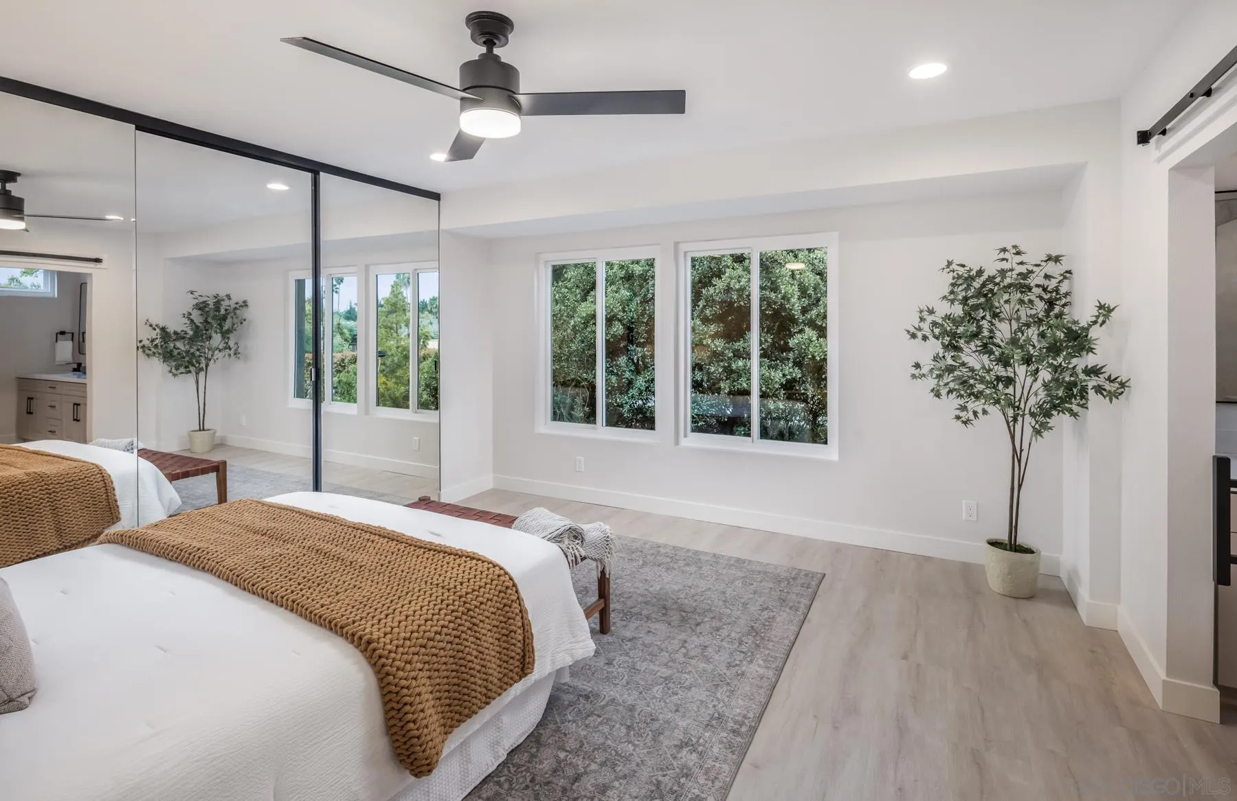 1999 Azure Way Encinitas, CA 92024 - Photo 12 of 27 a spacious bedroom with a large bed and a potted plant