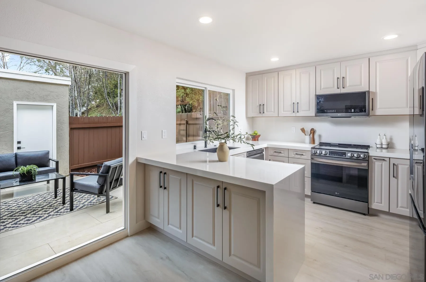 1999 Azure Way Encinitas, CA 92024 - Photo 26 of 27 a kitchen with stainless steel appliances a sink stove and cabinets