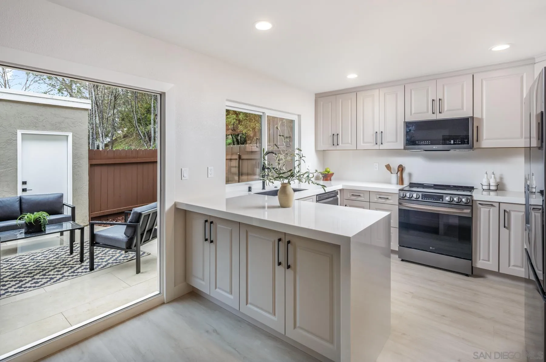 1999 Azure Way Encinitas, CA 92024 - Photo 4 of 27 a kitchen with stainless steel appliances a sink stove and cabinets