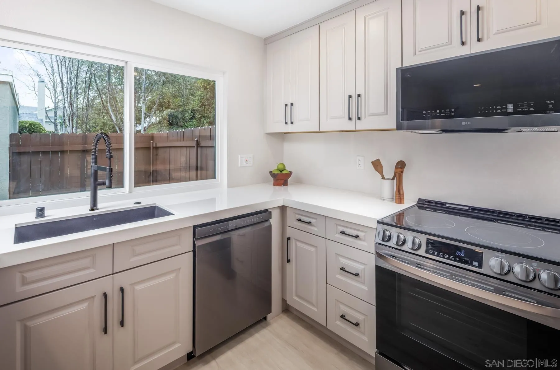1999 Azure Way Encinitas, CA 92024 - Photo 5 of 27 a kitchen with white cabinets and appliances