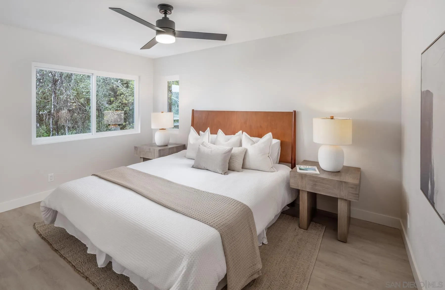 1999 Azure Way Encinitas, CA 92024 - Photo 8 of 27 a bedroom with a bed a chandelier and a window