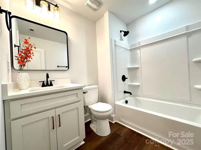 a bathroom with a sink vanity and mirror