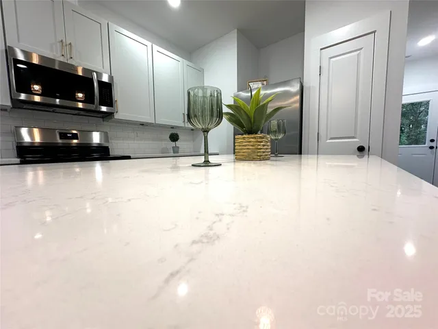 a view of kitchen with microwave and stove