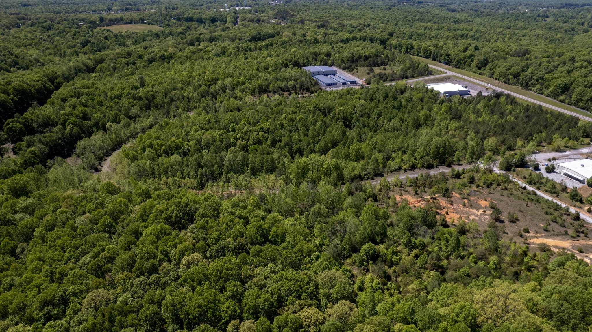 0 East Highway 70 White Bluff, TN 37187 - Photo 21 of 26 a view of a house with a lush green forest