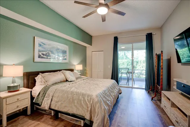 a spacious bedroom with a bed and a chandelier