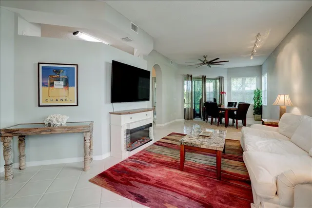 a living room with furniture dining table and a flat screen tv
