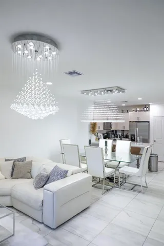 a living room with furniture and a chandelier