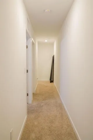 a view of hallway with a white wall