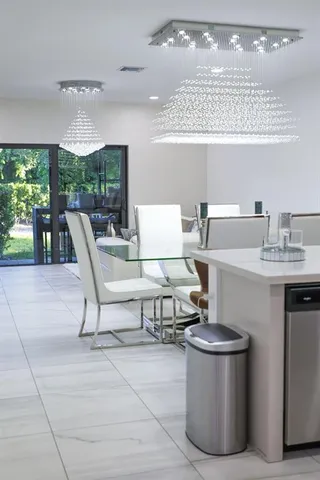 a living room with patio furniture and a floor to ceiling window