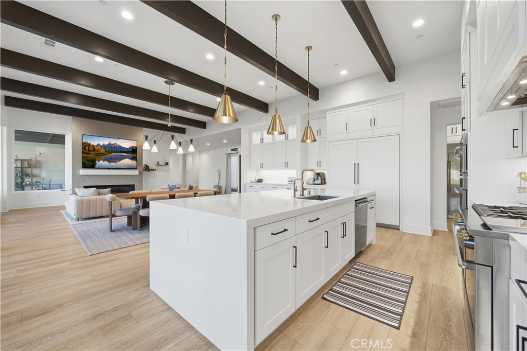 39788 Larkspur Terrace Temecula, CA 92591 - Photo 19 of 75 a large white kitchen with lots of counter space and stainless steel appliances