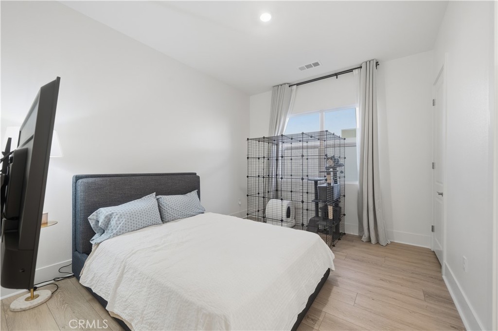 39788 Larkspur Terrace Temecula, CA 92591 - Photo 48 of 75 a bedroom with a large bed and a chandelier