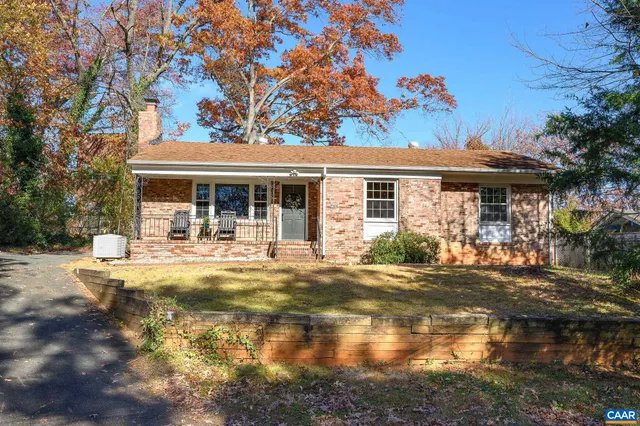 a view of a house with backyard porch and sitting area