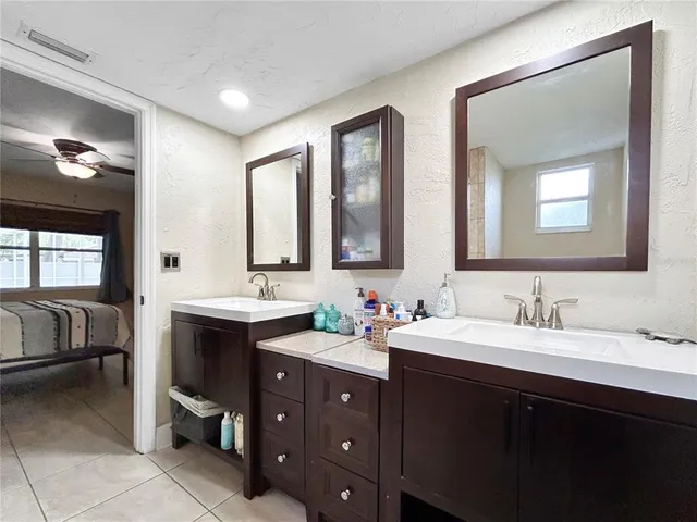 a bathroom with double vanity sinks and a mirror