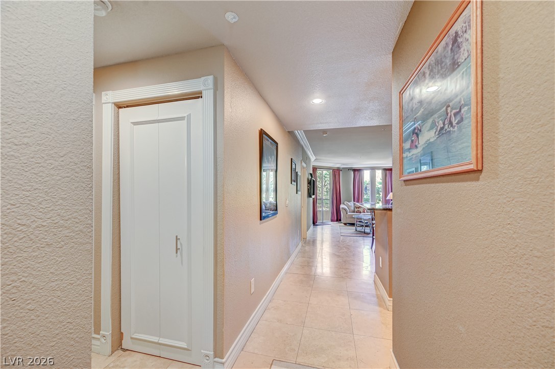 230 East Flamingo Road, Unit 333 Las Vegas, NV 89169 - Photo 7 of 61 Gleaming tile floors guide the eye down a welcoming hallway toward the main living space.