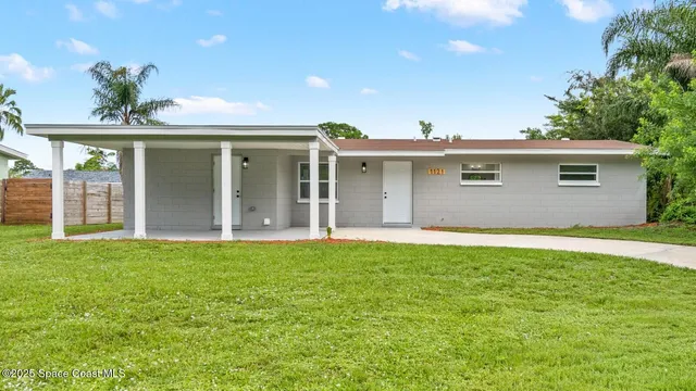 a front view of house with yard and outdoor seating
