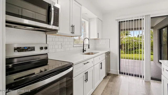 a kitchen with a sink cabinets and window