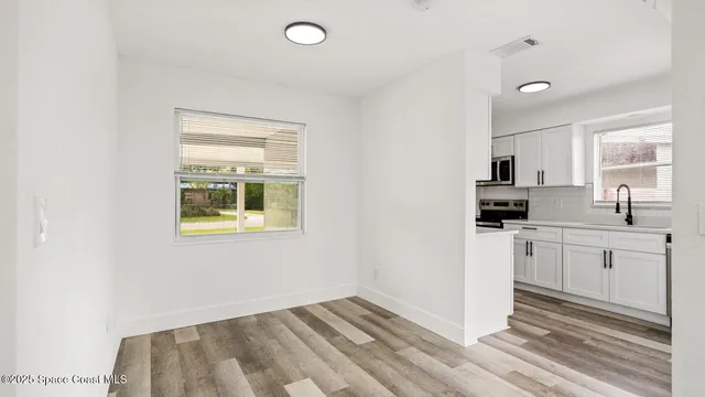 a view of entryway with wooden floor and door