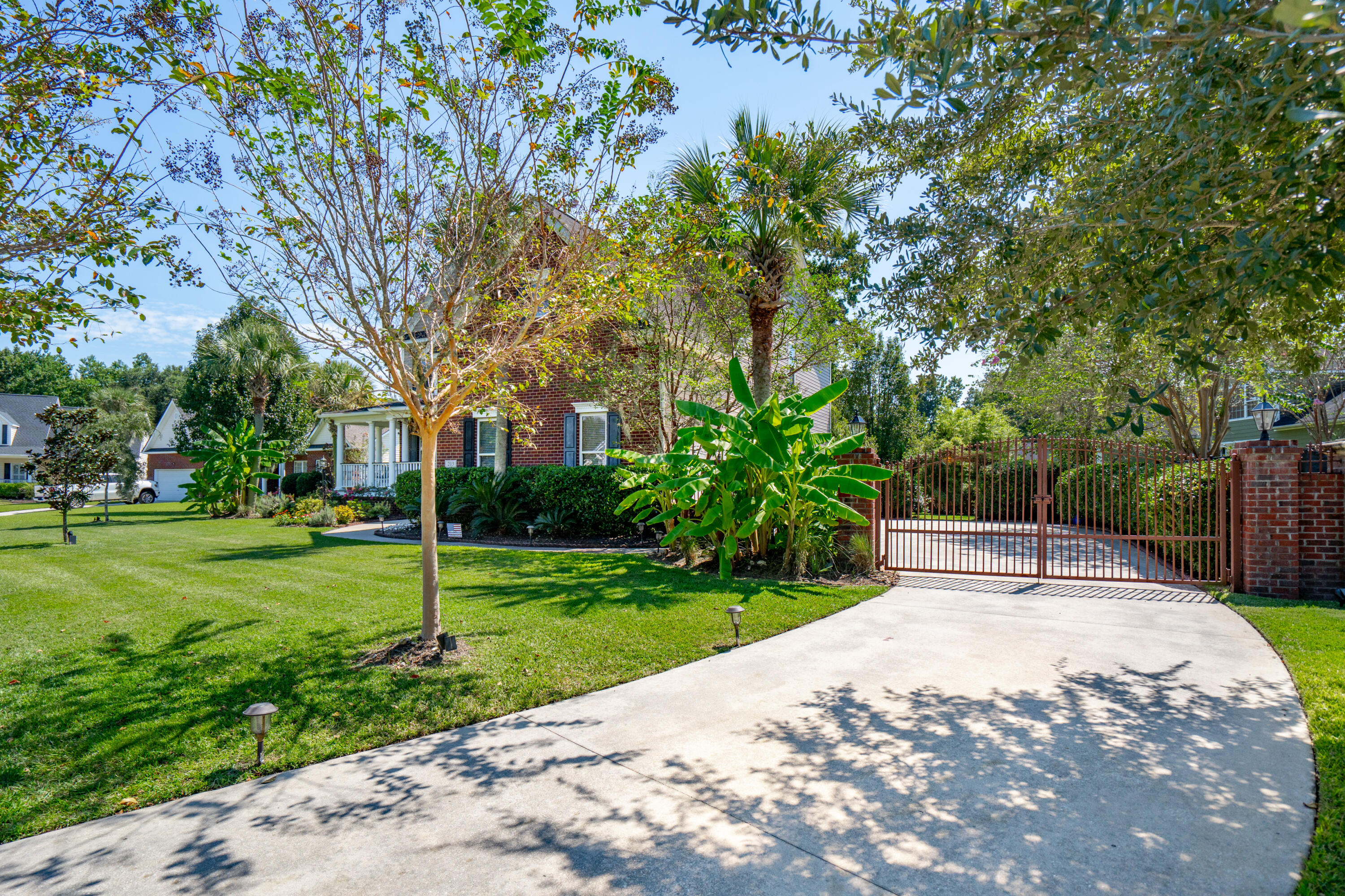 213 Harlech Way Charleston, SC 29414 - Photo 5 of 69 Driveway with iron gates and brick walls