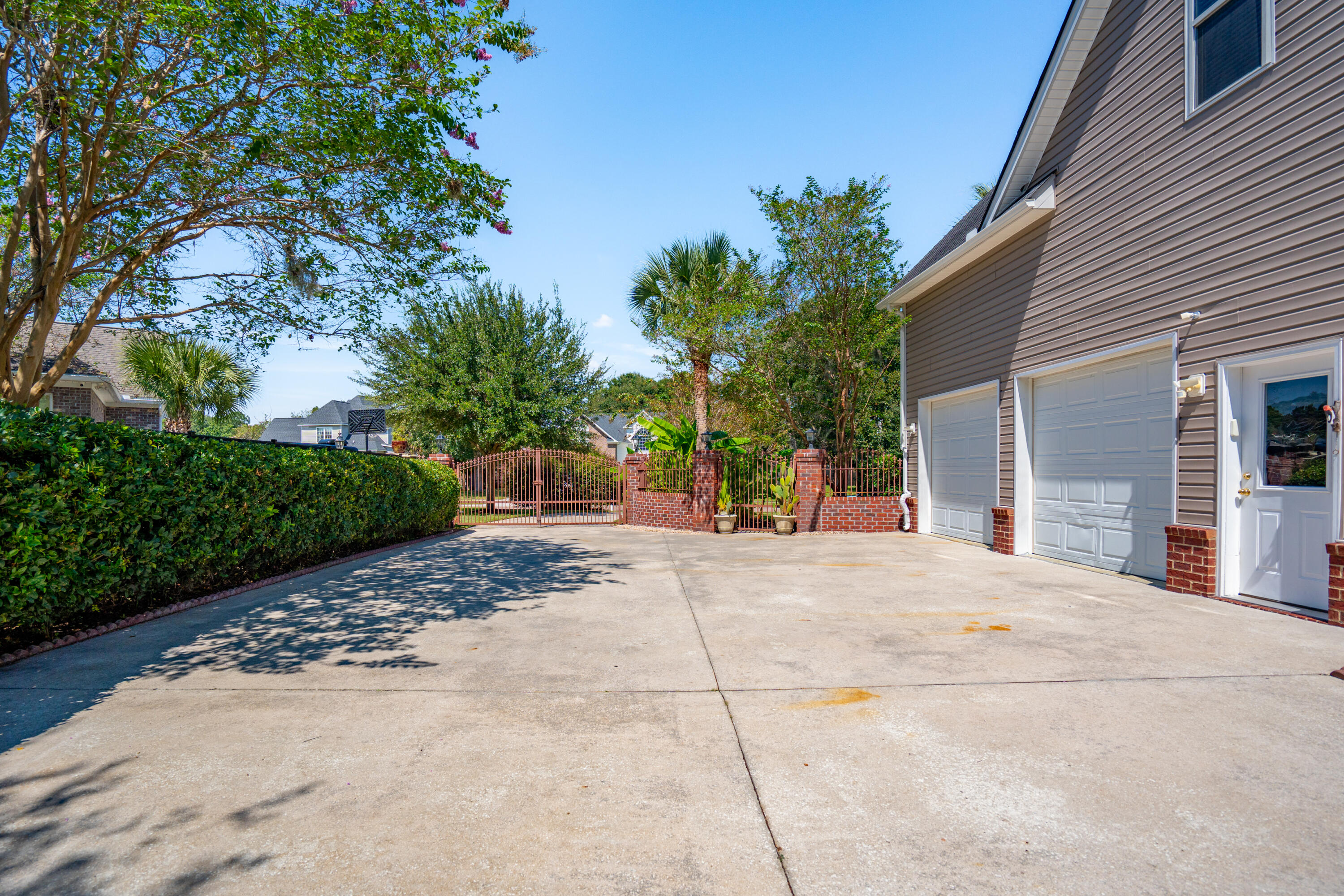 213 Harlech Way Charleston, SC 29414 - Photo 6 of 69 Driveway with iron gates and brick walls