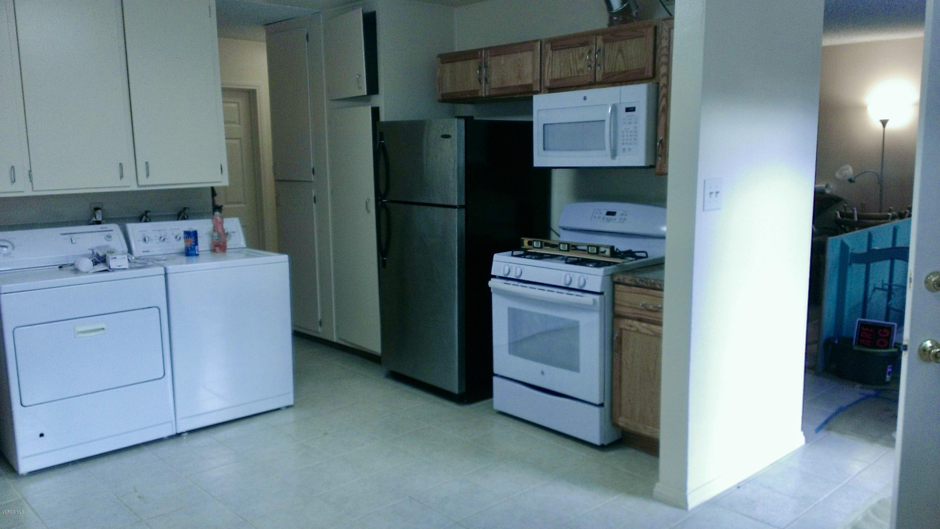 246 Valley Road Oak View, CA 93022 - Photo 11 of 34 a utility room with cabinets washer and dryer